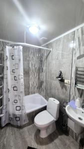 a bathroom with a white toilet and a sink at Садиба Святослав in Skhidnitsa +59 photos