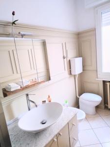 a white bathroom with a sink and a toilet at VM Ravenna Luxury Apartment in Ravenna +18 photos