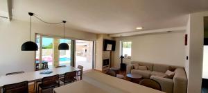 a living room with a table and a couch at Villas Salvore & Faro - Perfect combination of nature, sea and comfort, heated pool, games room, Savudrija - Istria in Savudrija