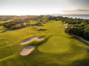 an aerial view of a golf course with a green at Villas Salvore & Faro - Perfect combination of nature, sea and comfort, heated pool, games room, Savudrija - Istria in Savudrija