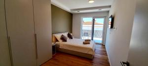 a bedroom with a bed and a view of the ocean at Villas Salvore & Faro - Perfect combination of nature, sea and comfort, heated pool, games room, Savudrija - Istria in Savudrija +77 photos