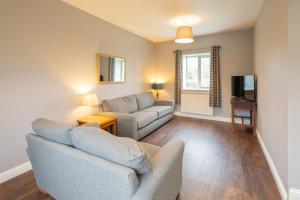 a living room with a couch and a table at Host & Stay - Croft Cottage in Pickering