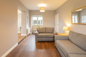 a living room with a couch and a chair at Host & Stay - Croft Cottage in Pickering +13 photos