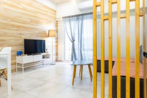 a bedroom with a bed and a tv and a table at P&K LUXURY APARTMENTS 1 in Kalamata