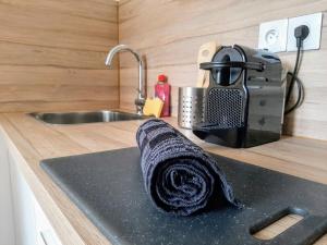 a kitchen counter with a towel on a sink at Les Apparts de Marmande - Petit Cocon en ville in Marmande