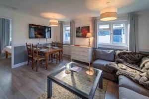 a living room with a couch and a table at Cedar Cabin Overlooking Bedgebury Forest in Goudhurst