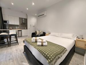 a bedroom with a large bed and a kitchen at InsideHome Ciudad del Cine in Valladolid +88 photos