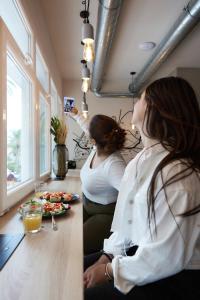 two women sitting at a counter taking a picture at Hostel Dos Estaciones - Albergue Juvenil - FREE towels, coffee & tea, remote check-in in Alicante +49 photos