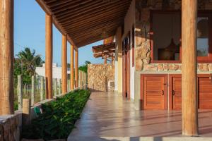 an external view of a house with a wooden walkway at Casa Licuri Corumbau in Corumbau +70 photos