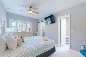 a bedroom with a bed and a ceiling fan at Relaxation Station in Key Colony Beach +18 photos