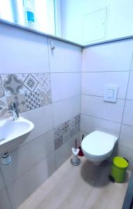 a bathroom with a toilet and a sink at Les rosieres 2 in Dom-le-Mesnil +6 photos