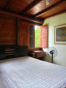 - une chambre avec un lit, une fenêtre et un ventilateur dans l'établissement Cabaña tipo chalet, à Morelia