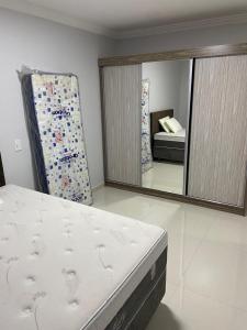 a bedroom with a mattress and a mirror at Ap novo ótima localização na avenida principal in Piratuba