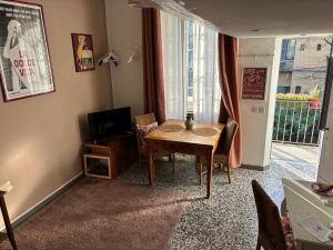 a living room with a table and a television at LOVELYLOFT, via Meda in Milan