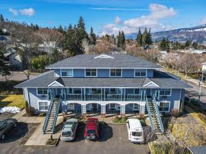 an aerial view of a blue house with parked cars at 15 Lodge in Hood River