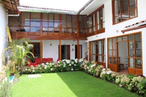 a large building with a yard with flowers at Casa Pablo in Cajamarca