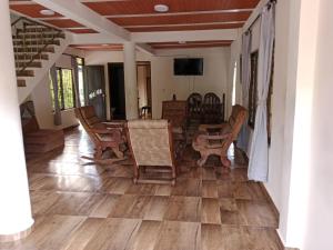 a dining room with a table and chairs on a wooden floor at Finca la mariana in Pereira