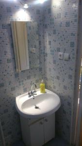 a bathroom with a white sink and a mirror at Red Locomotive Apartment in Budapest