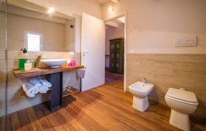 a bathroom with a sink and a toilet at Oasi Relax - Romantic Room & Spa in Torretta +2 photos