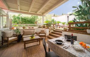 a patio with a table and chairs on a deck at Oasi Relax - Romantic Room & Spa in Torretta