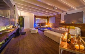 a large living room with a bed and a tv at Oasi Relax - Romantic Room & Spa in Torretta