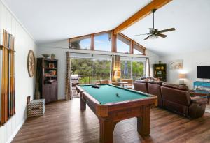 a living room with a pool table in it at Arrowhead Falls in Wimberley