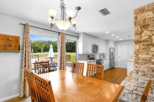a dining room and kitchen with a table and chairs at Arrowhead Falls in Wimberley