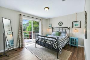 a bedroom with a bed and a sliding glass door at Arrowhead Falls in Wimberley +24 photos