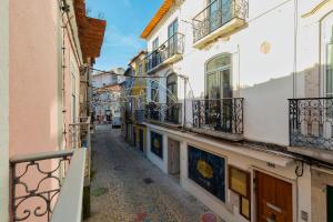 an alley in a town with white buildings at City Life in Setubal