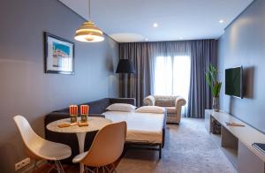 a living room with a couch and a table at Altis Prime Hotel in Lisbon