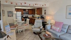 a living room with a couch and a kitchen at Seabreeze D in Holmes Beach