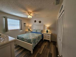 a bedroom with a bed and two night stands at Seabreeze D in Holmes Beach +14 photos