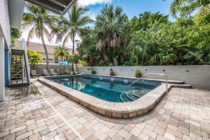 a swimming pool in a yard with a resort at Seabreeze D in Holmes Beach