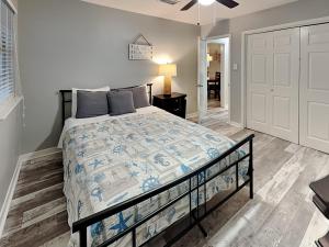 a bedroom with a bed in a room with a door at Pleasure Pier Retreat #4 in Galveston