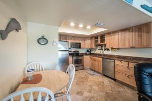 a kitchen with wooden cabinets and a table with chairs at Seabreeze A in Holmes Beach