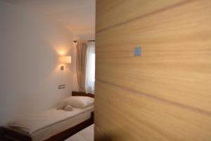 a bedroom with a bed in the corner of a room at Guest house Zavicaj Pale in Pale