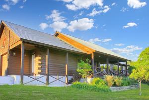 a wooden house with a gambrel roof at Deja View Cabin in Wimberley +8 photos