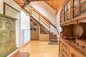 a large hallway with wooden floors and wooden stairs at Holiday house Podhamer Boris in Presika
