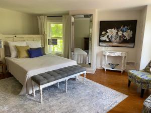 a bedroom with a large bed and a mirror at Trouvaille House Sweet Suite in Harpers Ferry