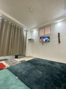 a living room with a large rug on the floor at la poste in Imouzzer Kandar