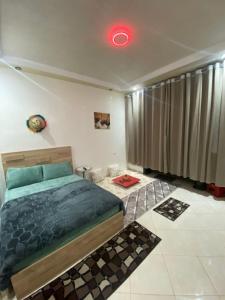 a bedroom with a bed and a red light at la poste in Imouzzer Kandar