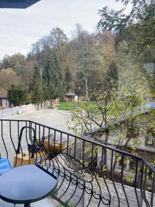 a balcony with a table and chairs and a fire hydrant at Apartamenty Przy Potoku in Ratno Dolne