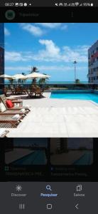 a picture of a pool with chairs and umbrellas at Flat no Beach Class Internacional, à beira-mar, em Boa Viagem, Recife-PE, com portaria e restaurante 24h - ideal para concursos, turismo, visto americano e jogos da série A - Piscina em reforma in Recife