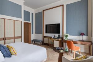 Rúm í herbergi á Hôtel Métropole Genève