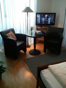 TV a/nebo společenská místnost v ubytování Heldts Aparthotel