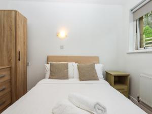a bedroom with a large white bed and a window at Castle View Lodge in Ilfracombe