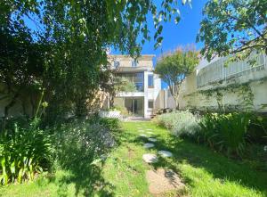 un jardín frente a un edificio en Chambre au calme sur jardin avec Terrasse, en La Rochelle