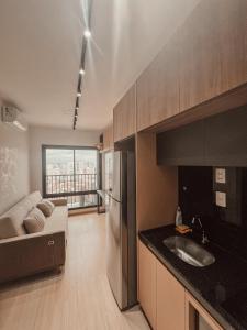 a kitchen with a sink and a couch in a room at Essential 2U in Sao Paulo +13 photos