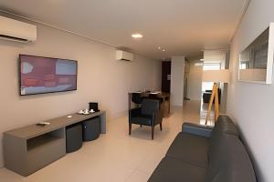 a living room with a couch and a table at Apartamento Super Luxo com vista in João Pessoa