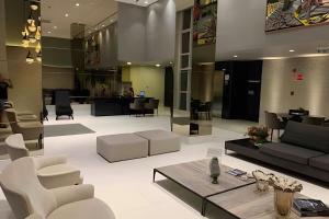 a living room with a couch and a table and chairs at Apartamento Super Luxo com vista in João Pessoa